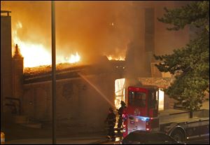 Firefighters are on the scene of a gas explosion and massive fire Tuesday night at JJ's restaurant at the Country Club Plaza in Kansas City, Mo.