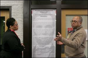 Kent library manager Faith A. Hairston and Brett Anthony Collins, a  librarian specialist at Kent’s Art Tatum African-American Resource Center, show a copy of the Emancipation Proclamation.