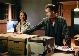 Jonny Lee Miller, right, as Sherlock Holmes and Lucy Liu as Joan Watson in a scene from the series, 