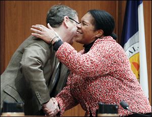 Councilman Rob Ludeman congratulates Paula Hicks-Hudson after she is sworn in as the president of Toledo City Council. Republican Tom Waniewski cast the only ‘no’ ballot in Tuesday’s vote.