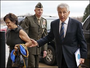 Marine Corp. Lt. Gen. Tom Waldheuser, center, greets Sen. Chuck Hagel, (R., Neb.), right, and his wife Lilibet, as they arrive at the Pentagon to be sworn-in as Secretary of Defense.