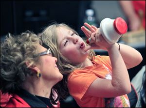 Trumpeter Gloria Buck of Walbridge watches as her granddaughter, Sylvia Freeman, 7, of Perrysburg, plays a silent solo on a trumpet mute at an Owens Community College Band rehearsal Feb. 18 at the college in Perrysburg Township.