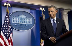 President Barack Obama walks away from the podium after speaking to reporters in the White House briefing room today in Washington.