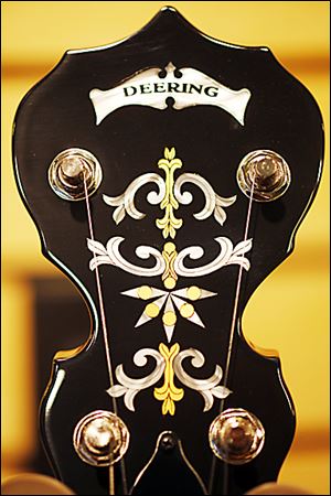 Inlays adorn the headstock of a Deering banjo at the Deering Banjo Co. A banjo can take from three hours to 20 hours to build. No nails are used in an instrument.