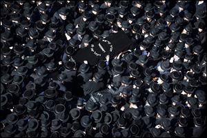 Members of the Satmar Orthodox Jewish community carry caskets to the funeral of two expectant parents who were killed in a car accident, Sunday in Brooklyn.