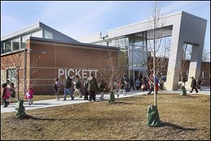 Students exit Pickett Academy in Toledo. Since 2002, Toledo Public Schools has undergone an extensive facilities upgrade, building or renovating more than 40 buildings. Pickett Academy was the last to open.