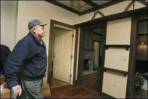 Douglas Pratt admires the wooden trim and pine flooring that he donated to the Perrysburg Area Historic Museum — otherwise known as the Aurora Spafford House — in Perrysburg. 