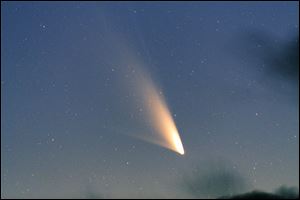 The recently discovered comet, Pan-STARRS, seen from Queenstown, New Zealand,is closer than it's ever been to Earth.