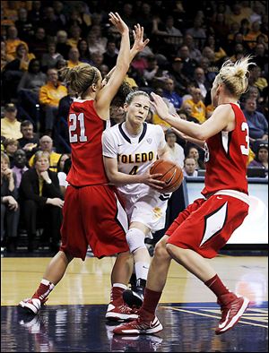 Naama Shafir drives through Ball State's Lyzz Smith (21) and Katie Murphy in the senior's final regular-season game in Toledo.