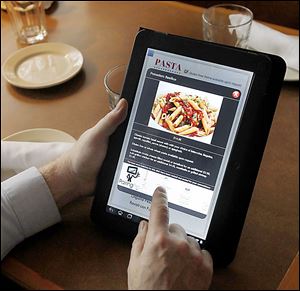 A diner uses an Acer tablet to select an entree at Ciao! Ristorante in Sylvania.