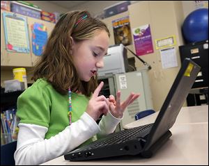 Savanna Brown, a third grader at Monroe Road Elementary School in Lambertville, figures out the answer to a math question as she and her classmates compete online against students from around the world during the World Education Games.