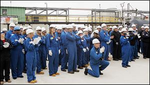 Workers and guests applaud after the ceremonial ribbon-cutting for Reformer 3. The unit takes low-octane gasoline — produced from crude oil at another part of the refinery — and rearranges the molecules to make a much higher-grade gas that can be blended for use in cars and trucks.