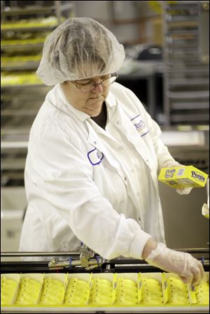 Gail Counterman adjusts a Peeps box as it move through the manufacturing process at the Just Born factory in Bethlehem, Pa.