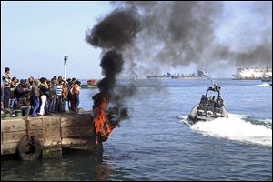 Several protesters set fire to tires on the city's dock today in an attempt to prevent ships from coming in to the strategic city of Port Said at the Mediterranean end of the Suez Canal, in Egypt.