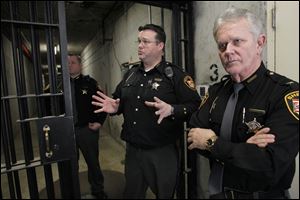 Deputy Brandon Stuard, left, Lt. Dave Friddell, and Sheriff John Tharp stand near the tunnel to the Lucas County Courthouse at the Corrections Center.