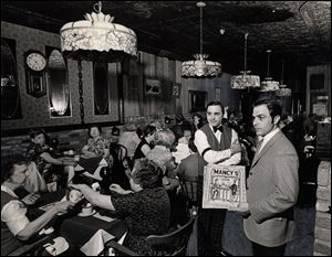 In May, 1968, customers dine under Tiffany lamps at Mancy’s Ideal Restaurant. The lamps were added, along with circus posters and a pot-bellied stove, about 1964.