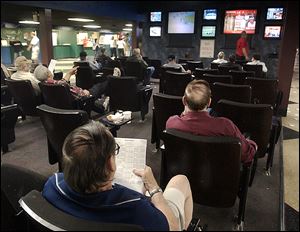 Fans watch races from Toledo and other tracks on monitors at Raceway Park, which will close next year to ease competition for the casino in East Toledo.