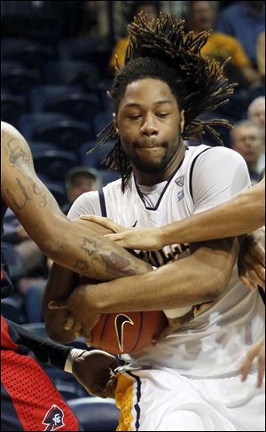 UT's Reese Holiday rips down a rebound.