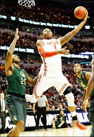 Ohio State's Deshaun Thomas shoots over Michigan State's Derrick Nix in a Big Ten semifinal. Thomas scored 16 points on 6-of-19 shooting in the Buckeyes' victory.