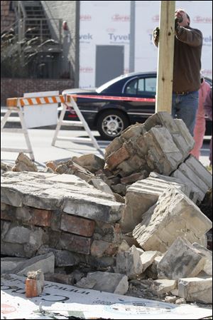 Ron Hurst, from Merritt Construction, works on the Boyd's Retro Candy Store after a car crashed into the store.