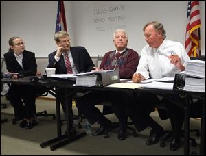 Lucas County Board of Elections member John Irish, right, make a motion to fire board director Meghan Gallagher, left, and deputy director Dan DeAngelis during a meeting at One Government Center. Listening are board member Jon Stainbrook, second from left, and Ron Rothenbuhler, board chairman. 