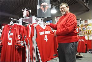 Al Luna, manager at The Buckeye Store and More! in Sylvania, says his store gets a boost from March Madness, but it is not as large as the sales jump it gets during football season.