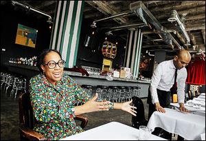 Torya Blanchard, owner of Rodin, an art gallery, music club, and ​restaurant, talks about being an entrepreneur in Detroit as waiter Robert Terry prepares for dinner. “If I worried about what’s going on with the city, I’d never get anything done,” she said.