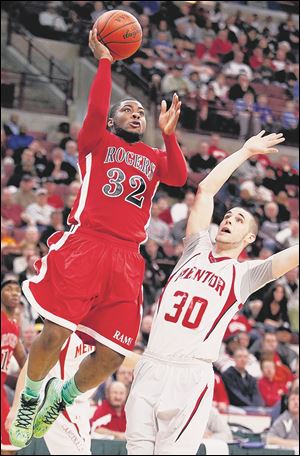 Rogers’ DeVonte Pratt goes to the net against Mentor’s Jeff Foreman during  the Division I state final in Columbus. Pratt scored 21 of his team-high 23 points by halftime. The Rams finished 21-8.