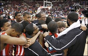 Rogers coach Earl Morris consoles his players after they lost in the Division I state championship game at Value City Arena in Columbus.