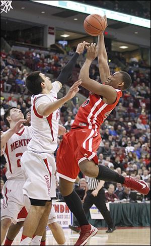 Rogers' Fadil Robinson goes up for a shot against Mentor's Brandon Fritts. Robinson finished with 10 points.