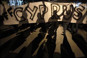 Protesters hold a banner that reads 