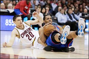 Philadelphia 76ers' Evan Turner, right, looks for help after grabbing a loose ball under pressure from the Cavaliers' Chris Quinn. Turner scored 23 points.