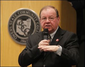 Mike Bower, President of Owens Community College, speaks at a forum at the school in 2012. Owens has announced layoffs to cope with projected budget shortfalls.