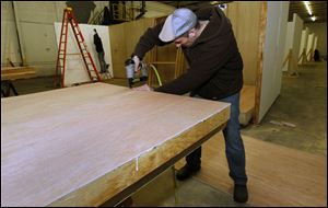 Volunteer Har Simrit Singh builds wall panels in preparation for Artomatic 419! at 911 Summit St. in Toledo, Ohio.