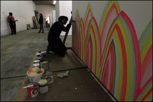 Toledo artist Natalie Lanese works on her collage and paint installation in preparation for Artomatic 419! at 911 Summit St. in Toledo, Ohio.