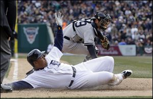 Detroit Tigers' Miguel Cabrera beats the tag of New York Yankees catcher Francisco Cervelli to score on a sacrifice fly by Victor Martinez during the fifth inning Saturday in Detroit.