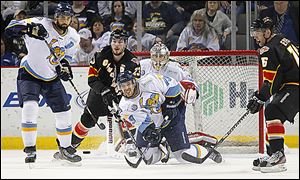 Toledo's Tyler Brenner (9) clears the puck in front of the Walleye goal.