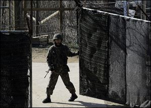 A South Korean soldier closes a military gate in Paju, north of Seoul, on Sunday. South Korean and U.S. officials believe North Korea may be setting the stage for another missile test, possibly as soon as this week. 