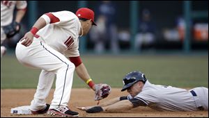 New York Yankees' Brett Gardner, right, is tagged out by Cleveland Indians' Asdrubal Cabrera in the fourth inning of a home opener baseball game.