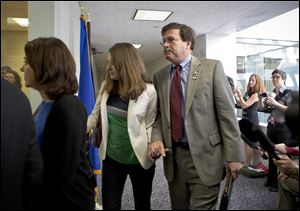 Bill Sherlach, with daughter Maura Lynn Schwartz, arrives with other families of the Newtown, Connecticut, school massacre to meet privately today on Capitol Hill in Washington.