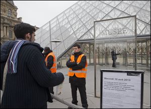 A visitor stands in front of to entrance in Louvre museum Paris, France, today. Paris' famed Louvre museum has been closed after workers walked off the job to protest what they say is the increasing problem of pickpockets.