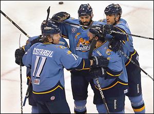 Walleye players celebrate after Travis Novak scored against the Cincinnati Cyclones in the third period.