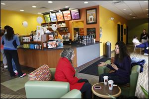 Cousins Lina Jarouche, center, and Eman Jarouche, right, chatted together Tuesday afternoon at the newest Biggby location in Sylvania.