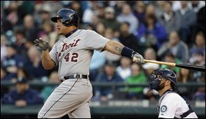 Detroit Tigers' Miguel Cabrera follows through on a one-run single as Seattle Mariners catcher Kelly Shoppach watches in the first inning Tuesday in Seattle.