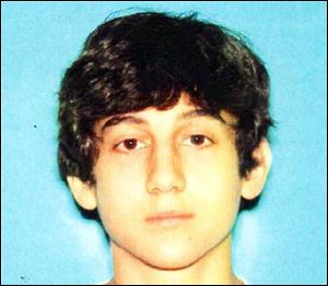 This image provided by the Boston Regional Intelligence Center shows Dzhokhar A. Tsarnaev, identified by the FBI as suspect number 2, in the Boston Marathon bombings. Authorities say Tsarnaev is still at large.