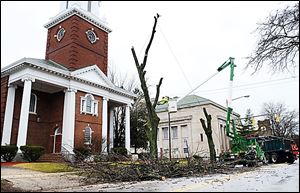 In January, crews with the Toledo Division of Parks and Forestry cut limbs from a tree along Collingwood Boulevard, north of Ban-croft Street, outside the GHDT Worship Center.