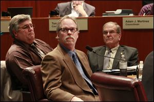 Department of Public Utilities commissioner, plant operations, David Leffler, left;  David Welch, DPU director, and Don Moline, DPU commissioner, field operations, watch Thursday during a presentation about the needs of the water department.