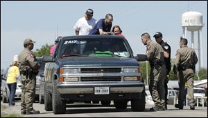 Displaced residents wait at a checkpoint for permission go back to their homes today, three days after an explosion at a fertilizer plant in West, Texas.