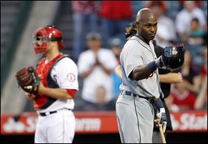 Detroit Tigers' Torii Hunter tips his helmet to the Los Angeles Angels bench prior to hitting in the first inning during. Hunter returned to Anaheim for the first time after playing five seasons for the Angels.