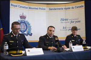 Assistant Commissioner James Maliza, officer in charge of Federal Policing Operations, center, is flanked by Chief Superintendent Gaetan Courchesne, Royal Canadian Mounted Police criminal operations officer in the province of Quebec, left, and Chief Superintendent Jennifer Strachan RCMP criminal operations officer in the province of Ontario at a news conference in Toronto on Monday.